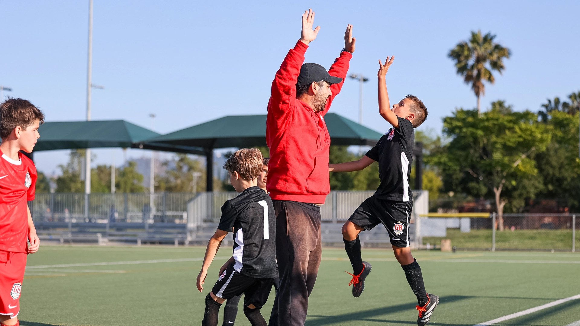Big kids playing soccer at GB Soccer School